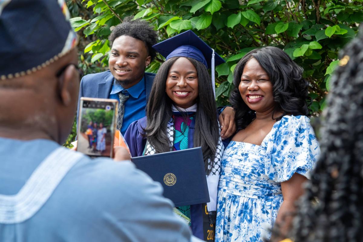 Student with family on either side of her