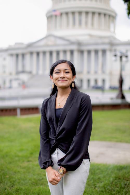 young woman smiling in front of the capitol building in washington, dc