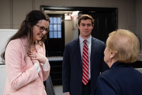 Madeleine Albright talking with two students