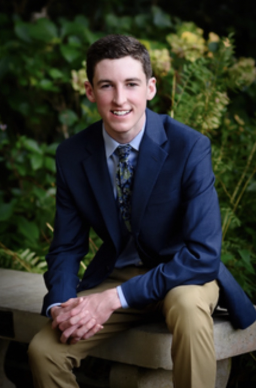 Young man in blue suit smiling at camera
