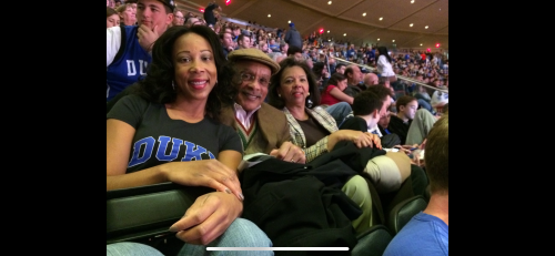 People smiling at camera at Duke basketball game