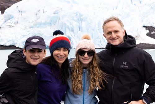 four people in snow smiling at camera