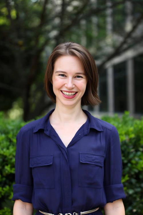 Woman with bright smile, purple shirt