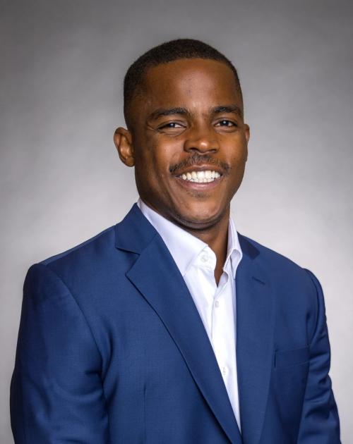 Man wearing a blazer smiling
