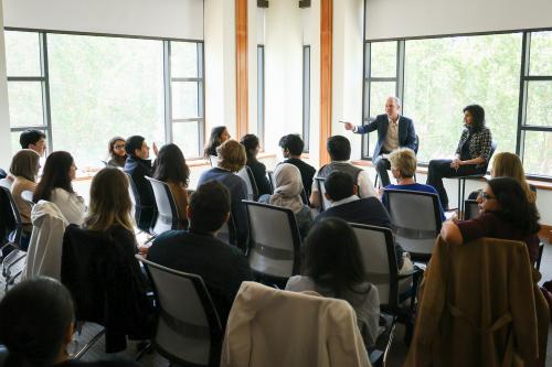 Professor pointing to student with raised hand for question