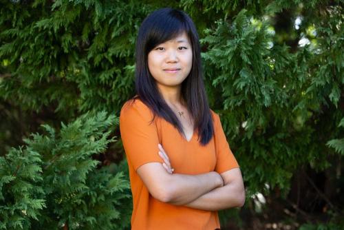 Woman, looks serious with arms crossed