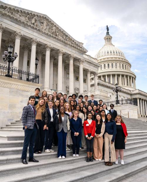 Students posing on the steps of the Capitol